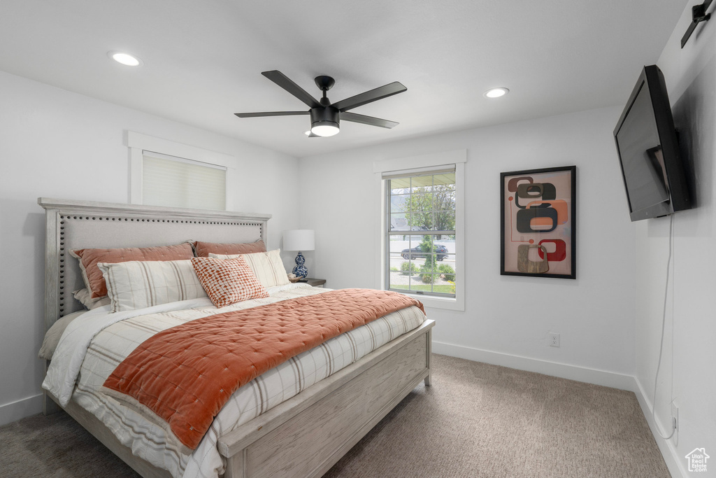 Bedroom with ceiling fan and dark carpet