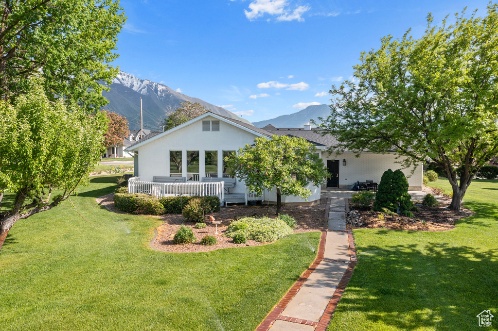 View of front of house featuring a front yard and a mountain view