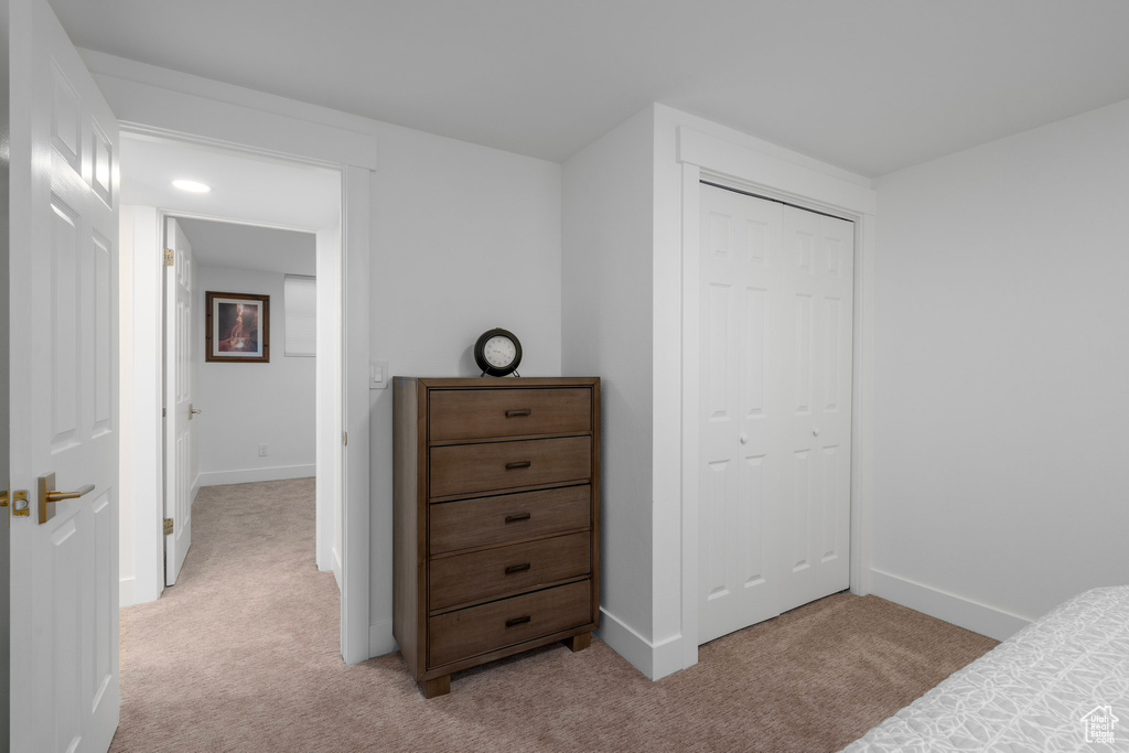 Carpeted bedroom with a closet