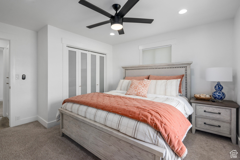 Bedroom with ceiling fan and carpet floors