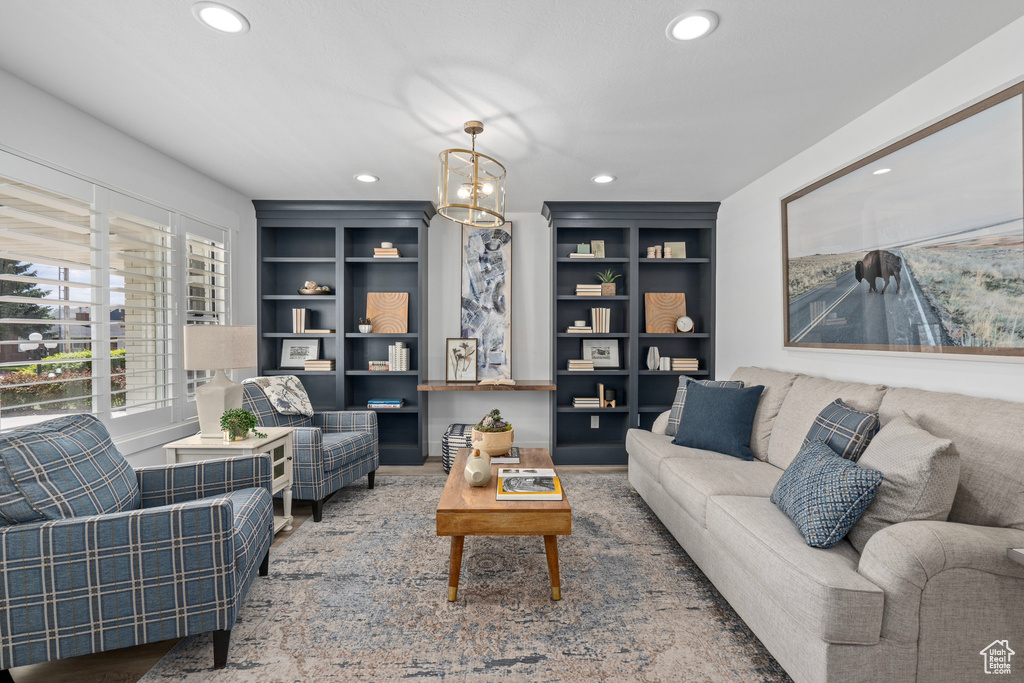 Living room featuring built in features and a chandelier