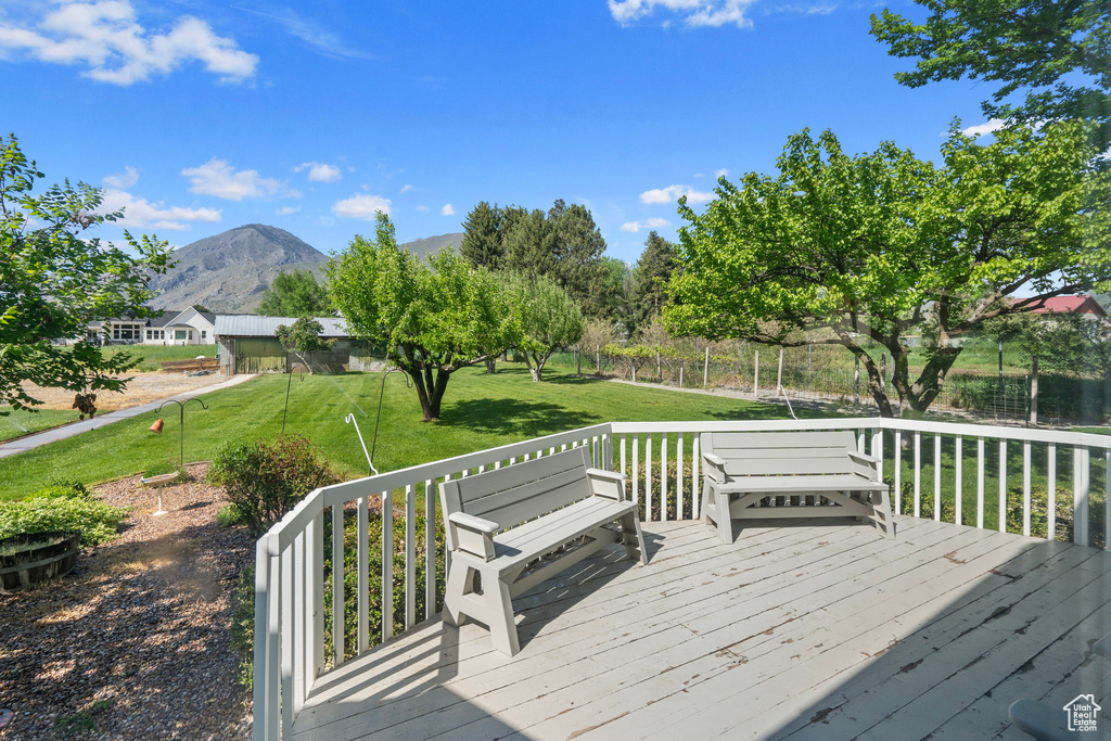 Deck featuring a mountain view and a yard