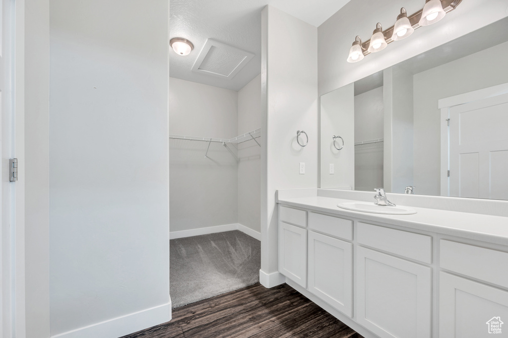 Bathroom featuring vanity and wood-type flooring