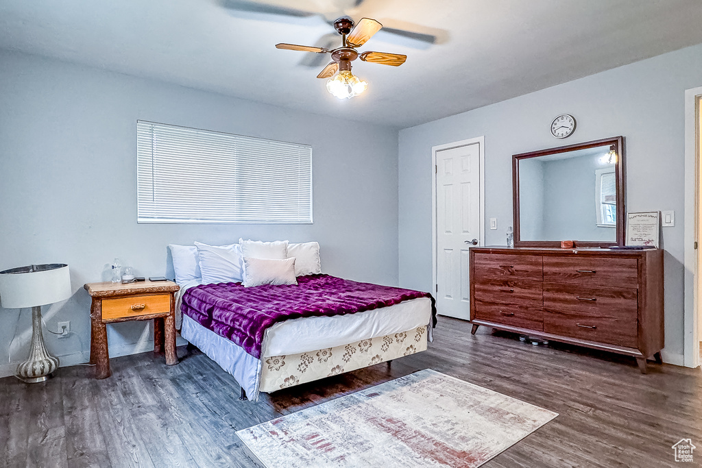 Bedroom with ceiling fan and dark wood-type flooring