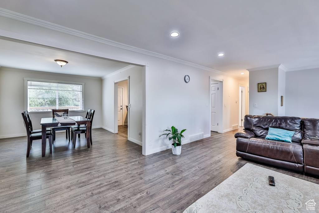 Living room featuring ornamental molding and hardwood / wood-style floors