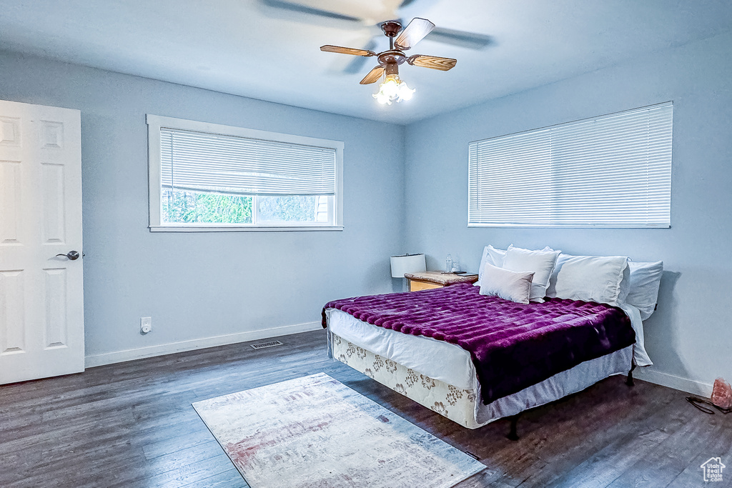 Bedroom featuring dark hardwood / wood-style floors and ceiling fan