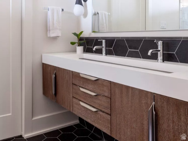 Bathroom with tile floors, backsplash, and vanity