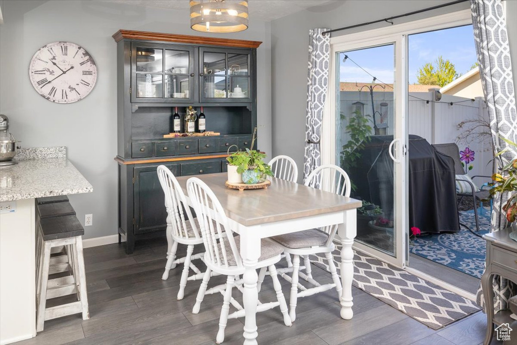 Dining area with dark wood-type flooring