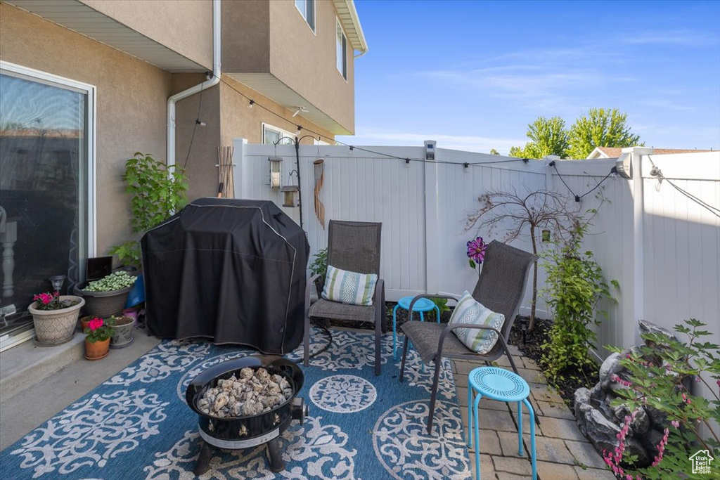 View of patio / terrace with a fire pit and grilling area