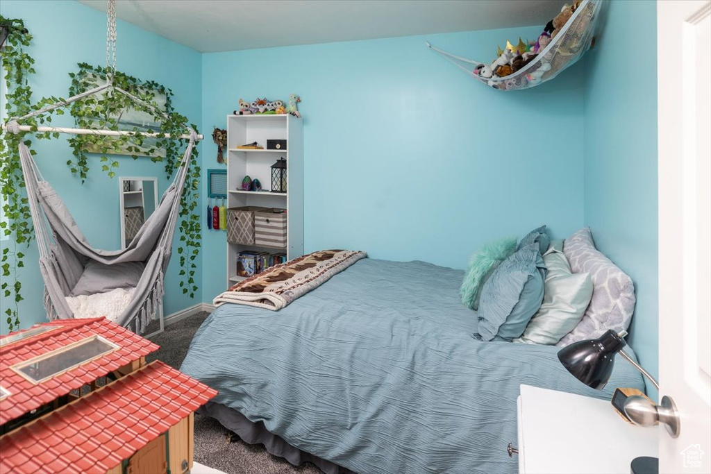 Bedroom featuring dark carpet