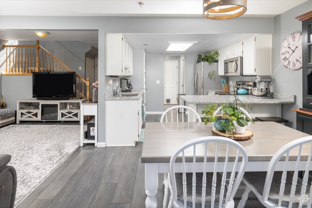 Dining area featuring sink and dark hardwood / wood-style flooring