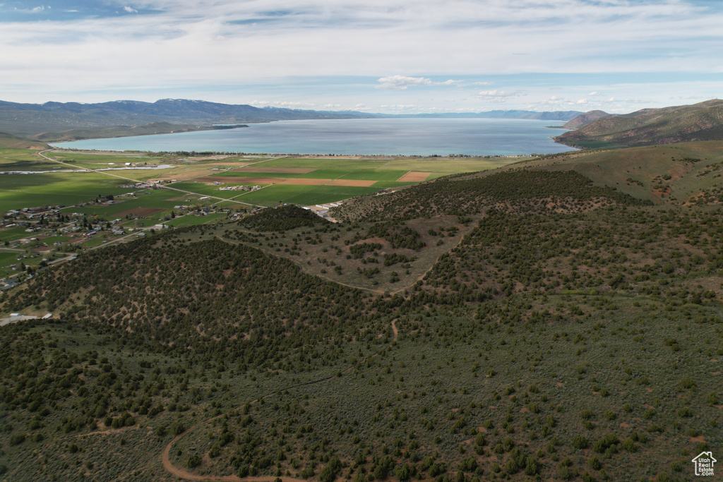 Birds eye view of property featuring a water and mountain view