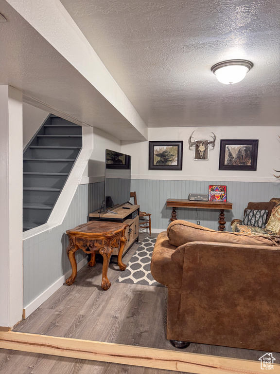 Living room featuring hardwood / wood-style flooring and a textured ceiling