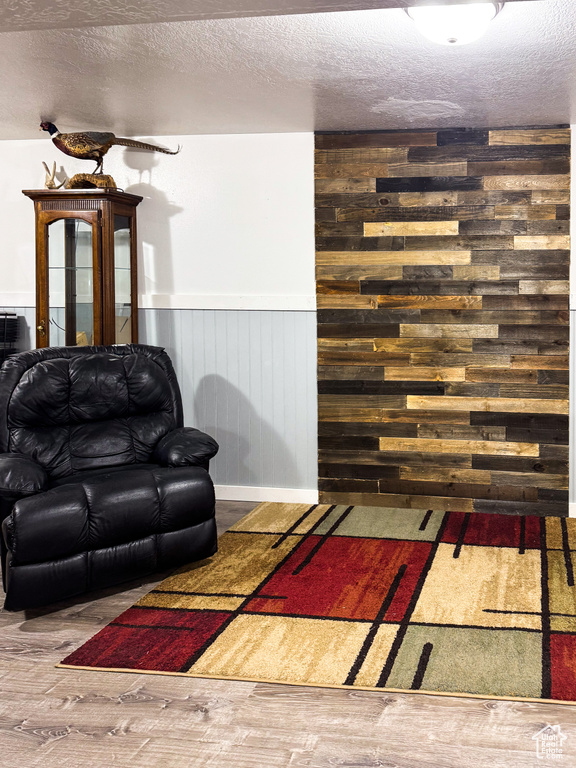 Living room featuring hardwood / wood-style floors and a textured ceiling