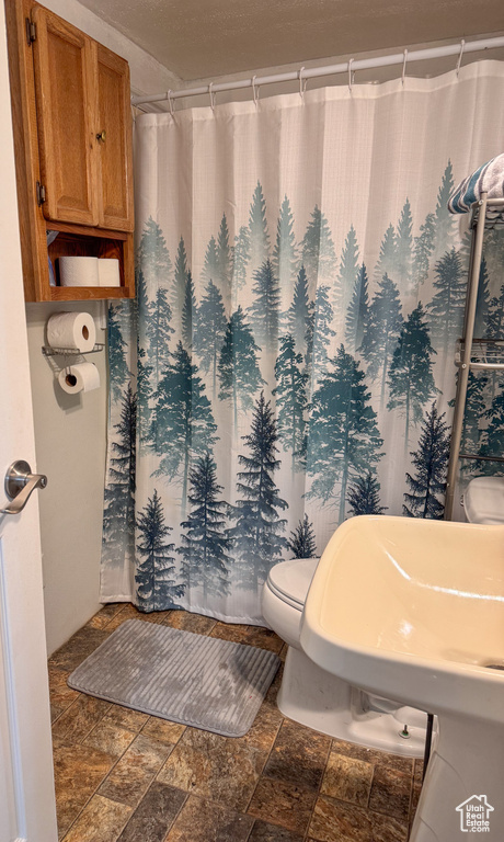 Bathroom with tile flooring and toilet