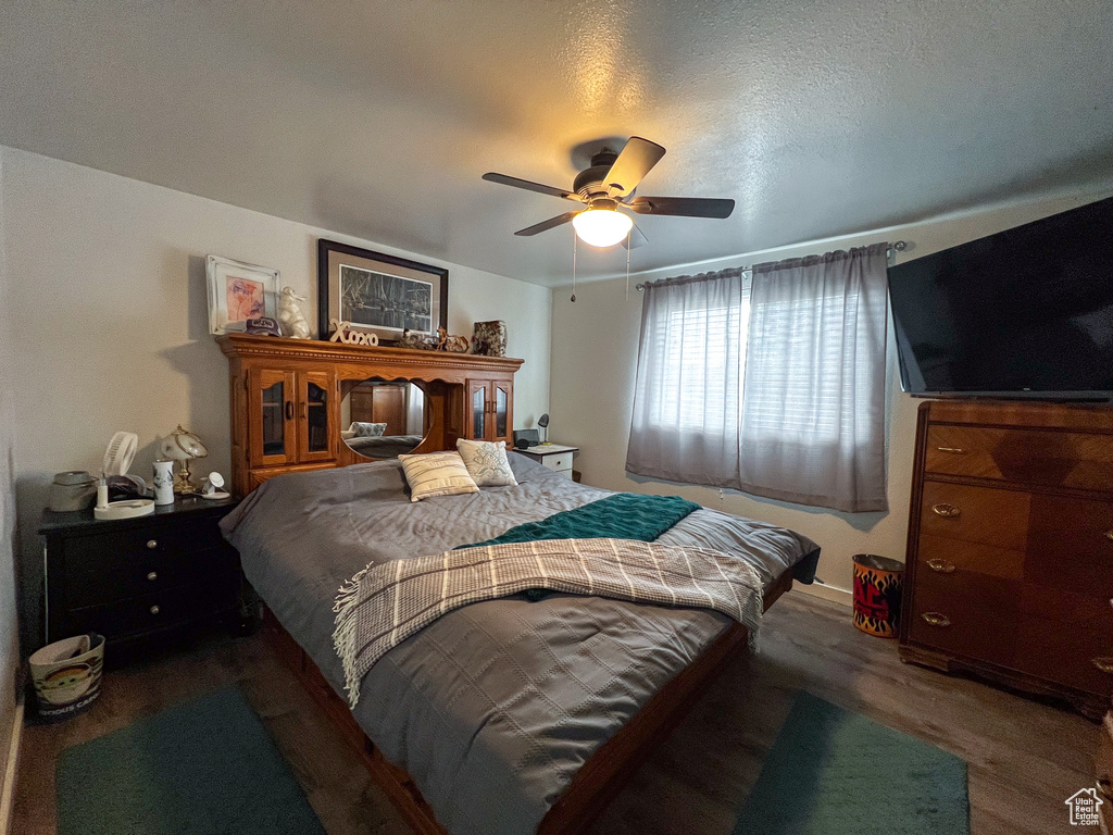 Bedroom featuring a textured ceiling, ceiling fan, and hardwood / wood-style floors