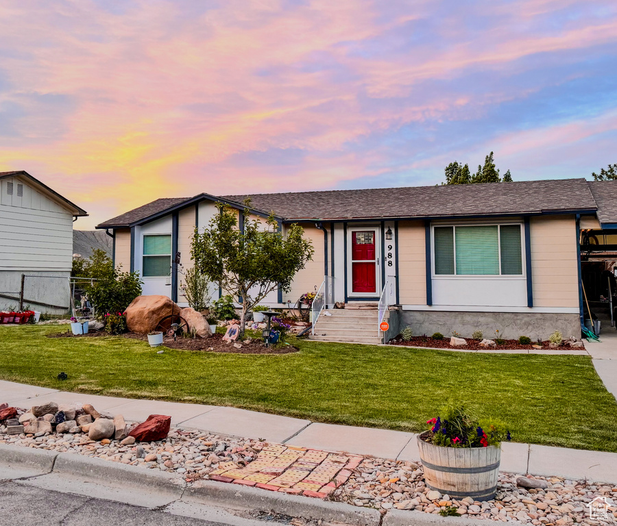 Ranch-style house with a lawn