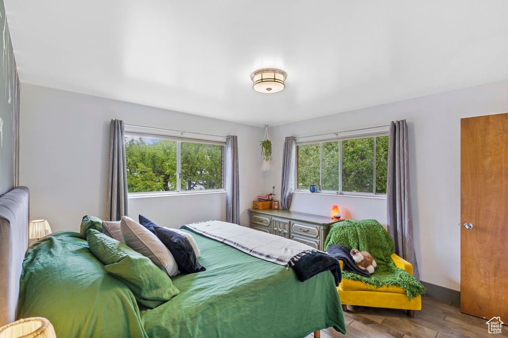 Bedroom featuring multiple windows and hardwood / wood-style flooring