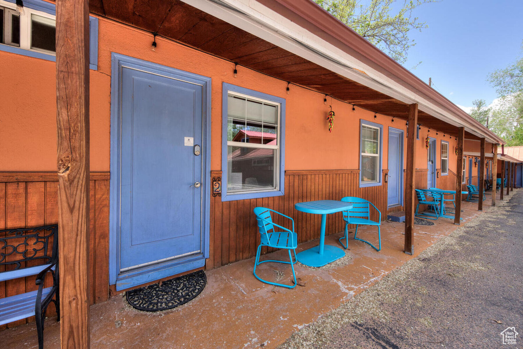 View of exterior entry with a patio