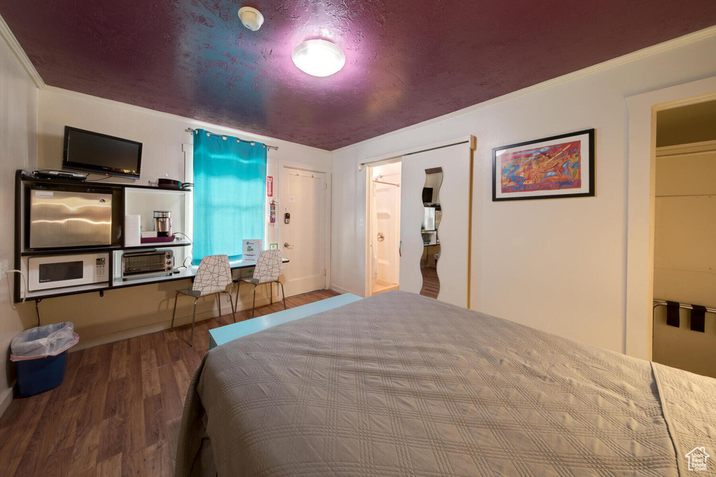 Bedroom with wood-type flooring