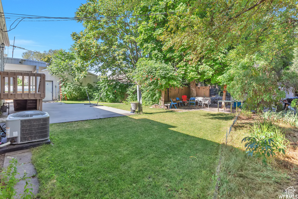 View of yard with a patio area and central AC