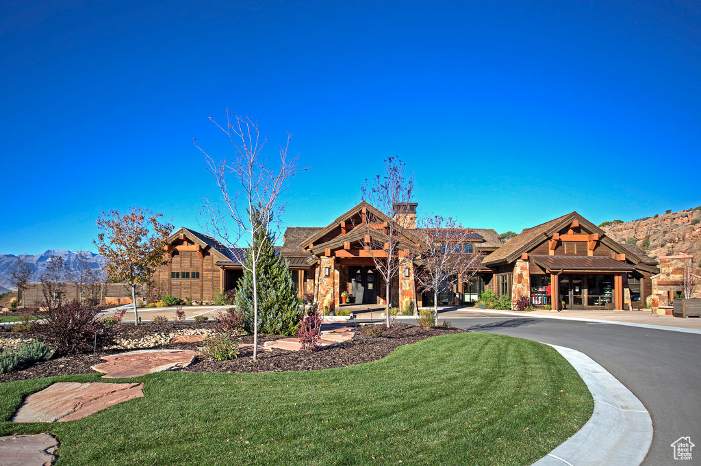 Exterior space with a front yard and a mountain view