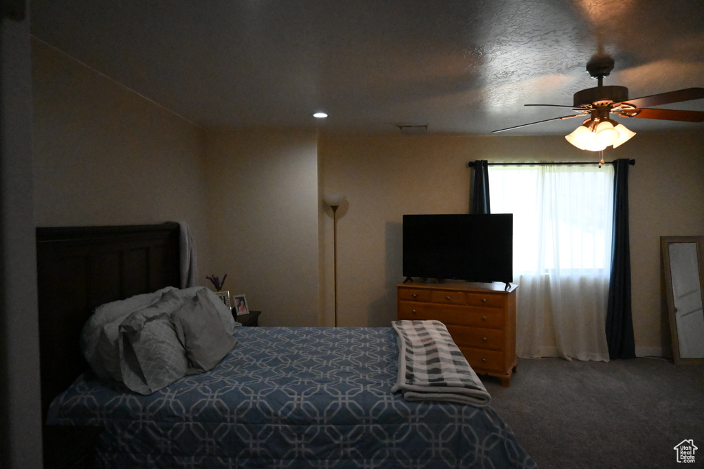 Bedroom featuring ceiling fan and carpet floors