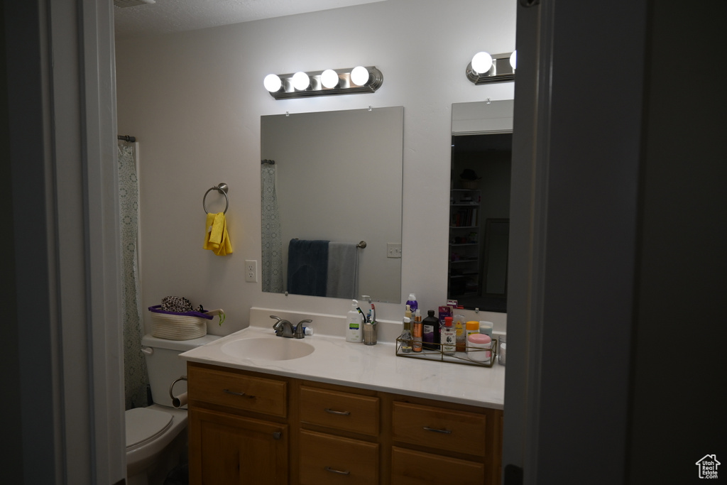 Bathroom with oversized vanity and toilet