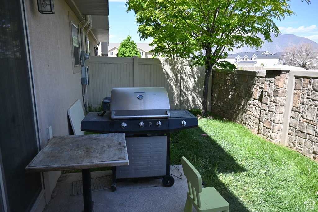 View of terrace with a mountain view and area for grilling