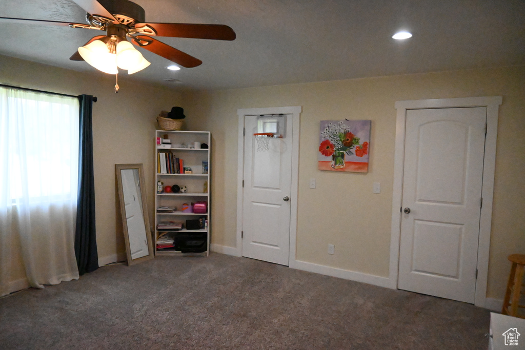 Unfurnished bedroom featuring carpet and ceiling fan