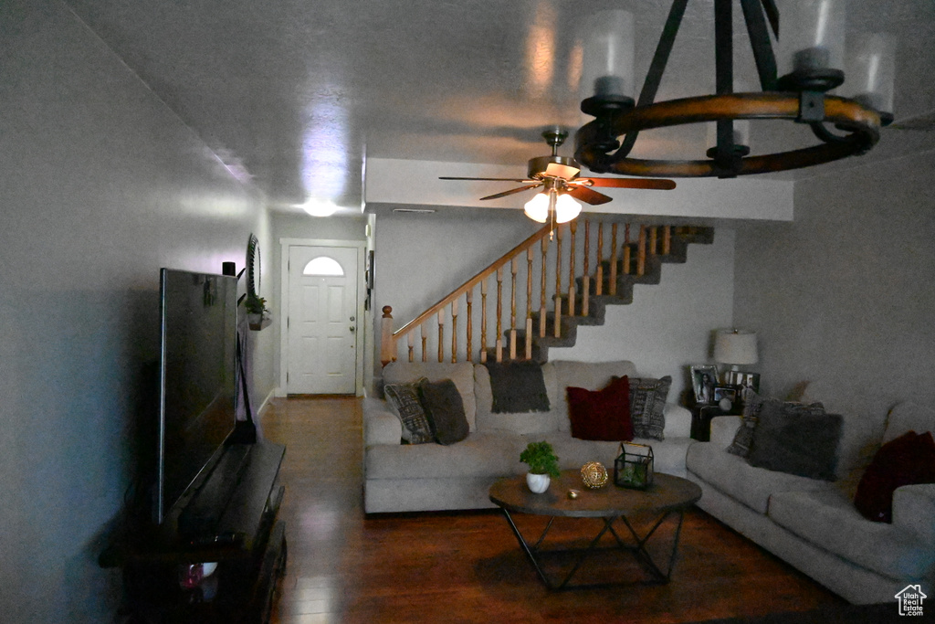 Living room featuring wood-type flooring and ceiling fan