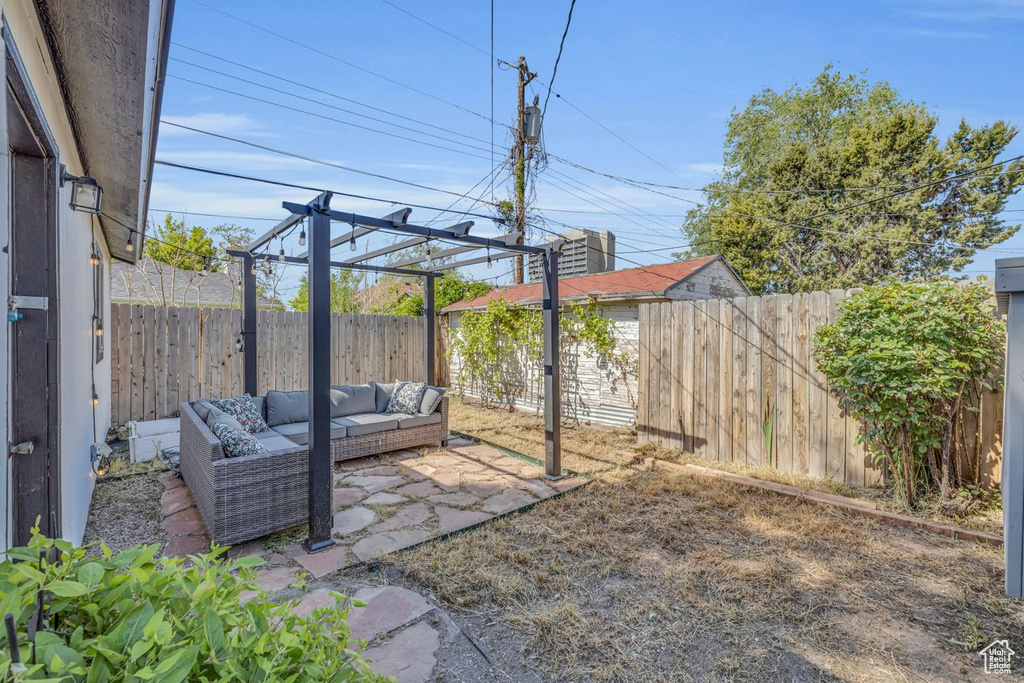 View of yard with a pergola, a patio, and an outdoor hangout area