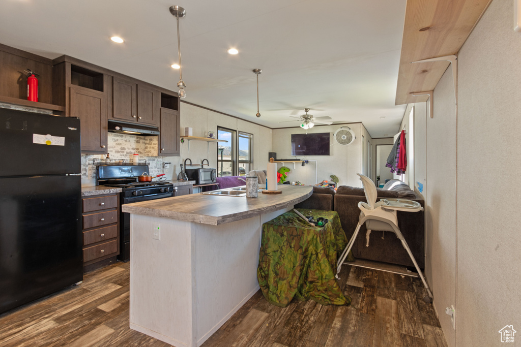 Kitchen featuring black appliances, dark hardwood / wood-style floors, backsplash, sink, and ceiling fan