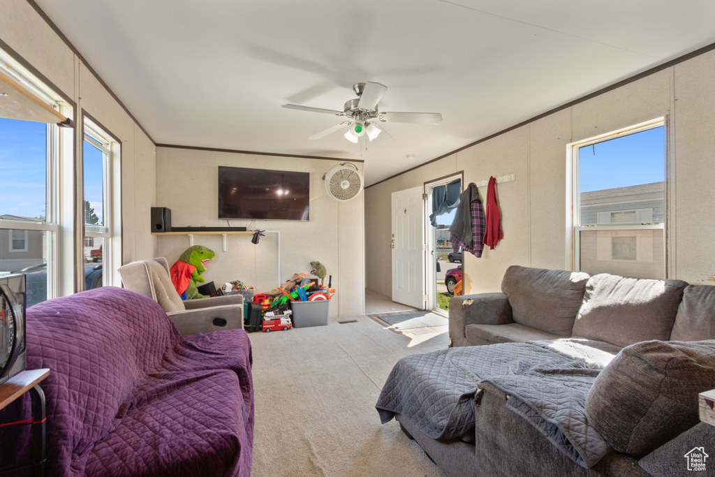 Carpeted living room with ceiling fan