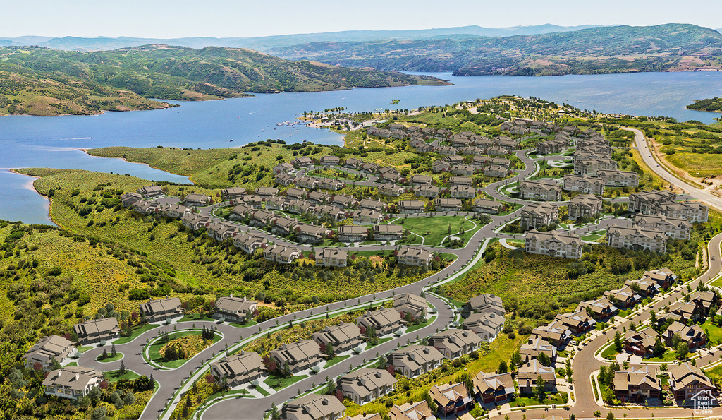 Drone / aerial view featuring a water and mountain view