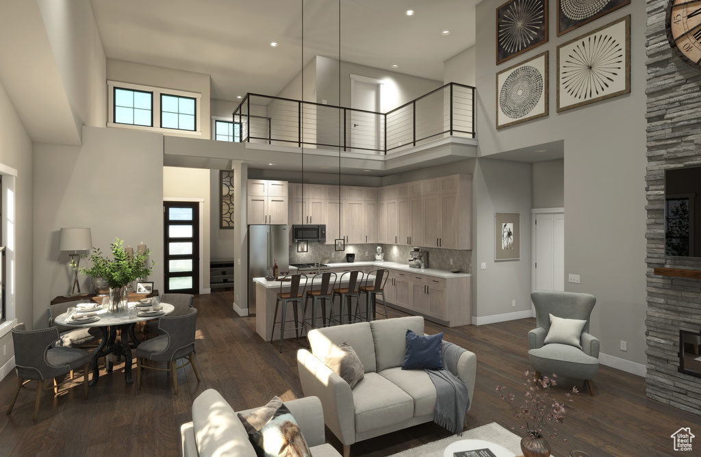 Living room with a towering ceiling and dark wood-type flooring