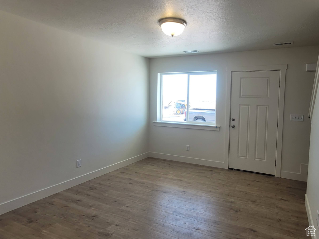 Unfurnished room with light wood-type flooring