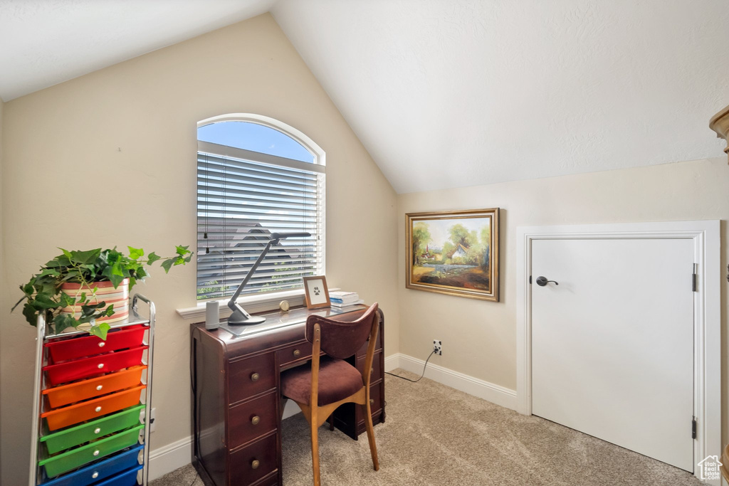 Carpeted office space with vaulted ceiling