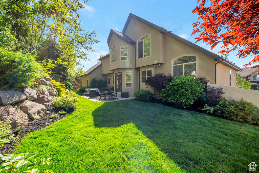 Exterior space featuring a patio and a yard