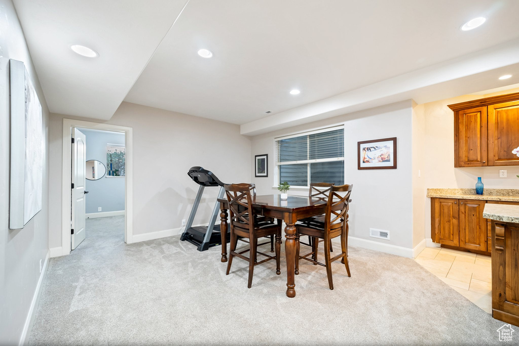 Dining area with light colored carpet