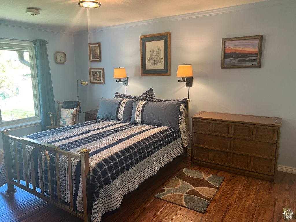 Bedroom featuring dark hardwood / wood-style floors and ornamental molding