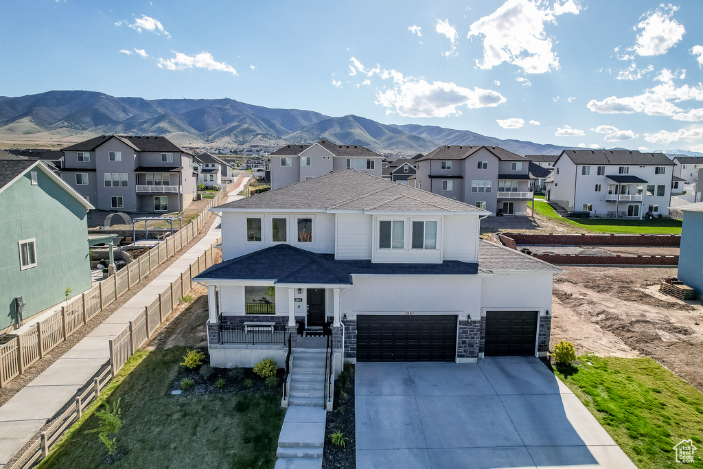 View of front facade featuring a garage and a mountain view