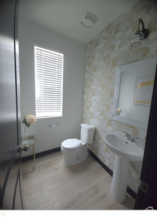 Bathroom featuring hardwood / wood-style flooring and toilet