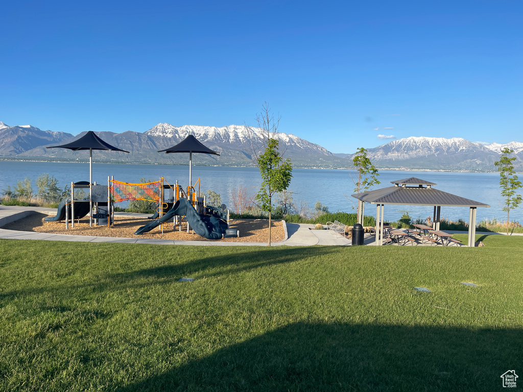 View of yard featuring a playground, a gazebo, and a water and mountain view