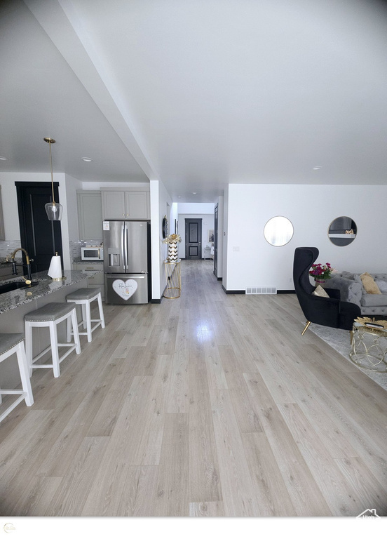 Interior space featuring sink and light wood-type flooring