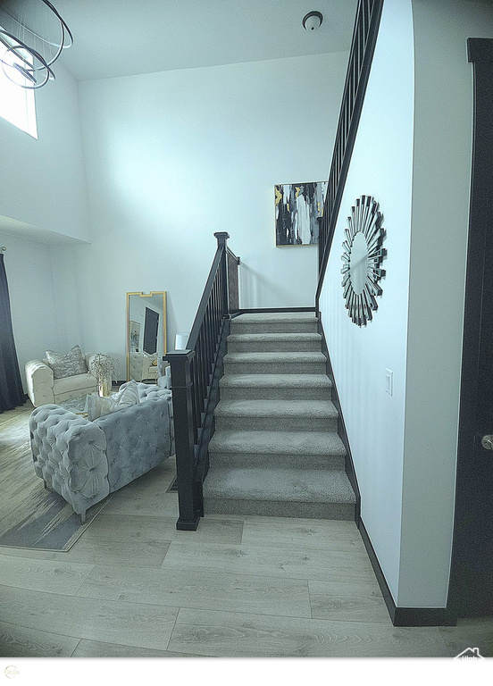 Stairway with hardwood / wood-style flooring