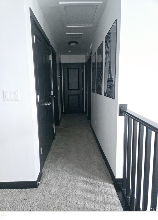 Corridor with dark colored carpet