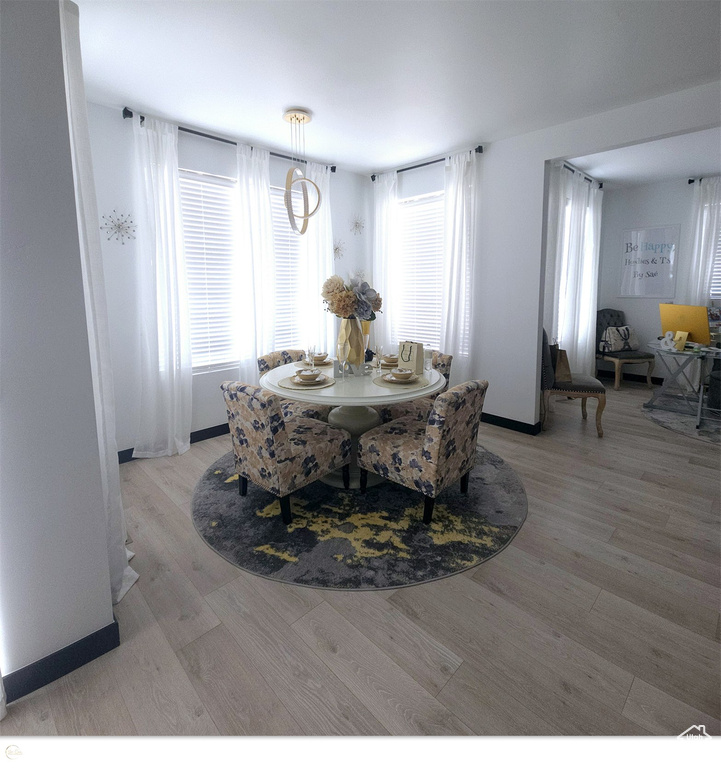 Dining area with light hardwood / wood-style flooring