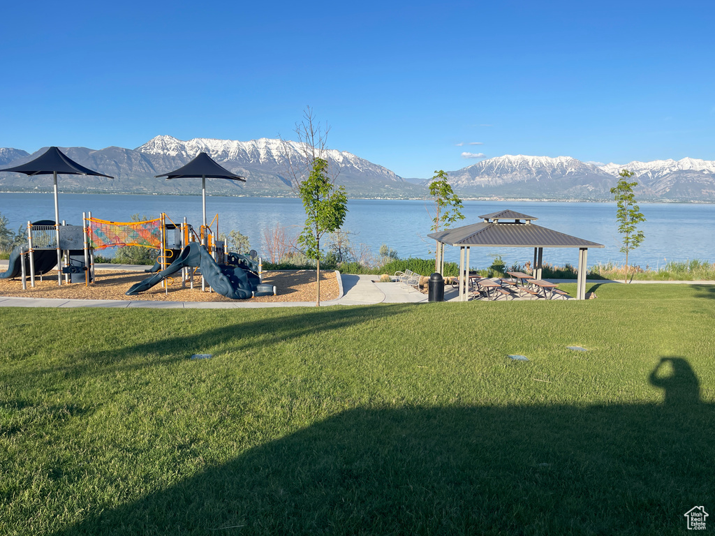 View of yard with a playground, a water and mountain view, and a gazebo