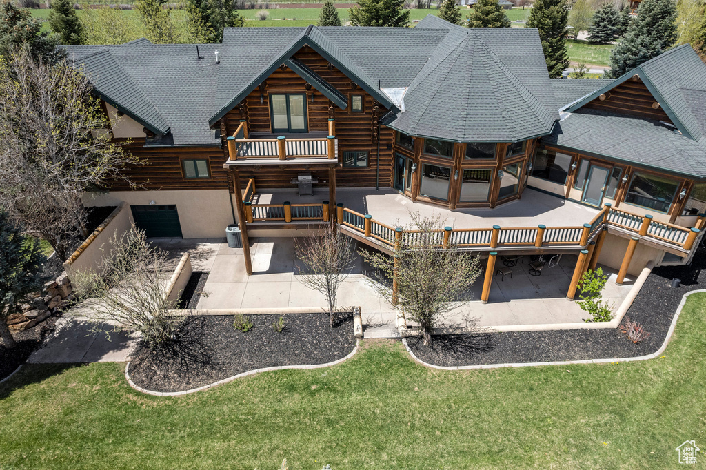 Rear view of property featuring a yard